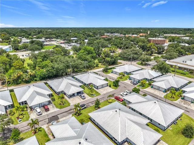 an aerial view of residential houses with outdoor space and ocean view