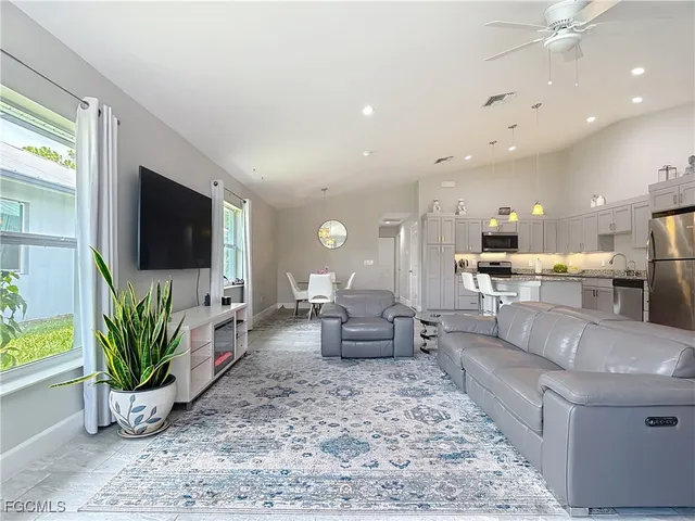 a living room with fireplace furniture and a flat screen tv