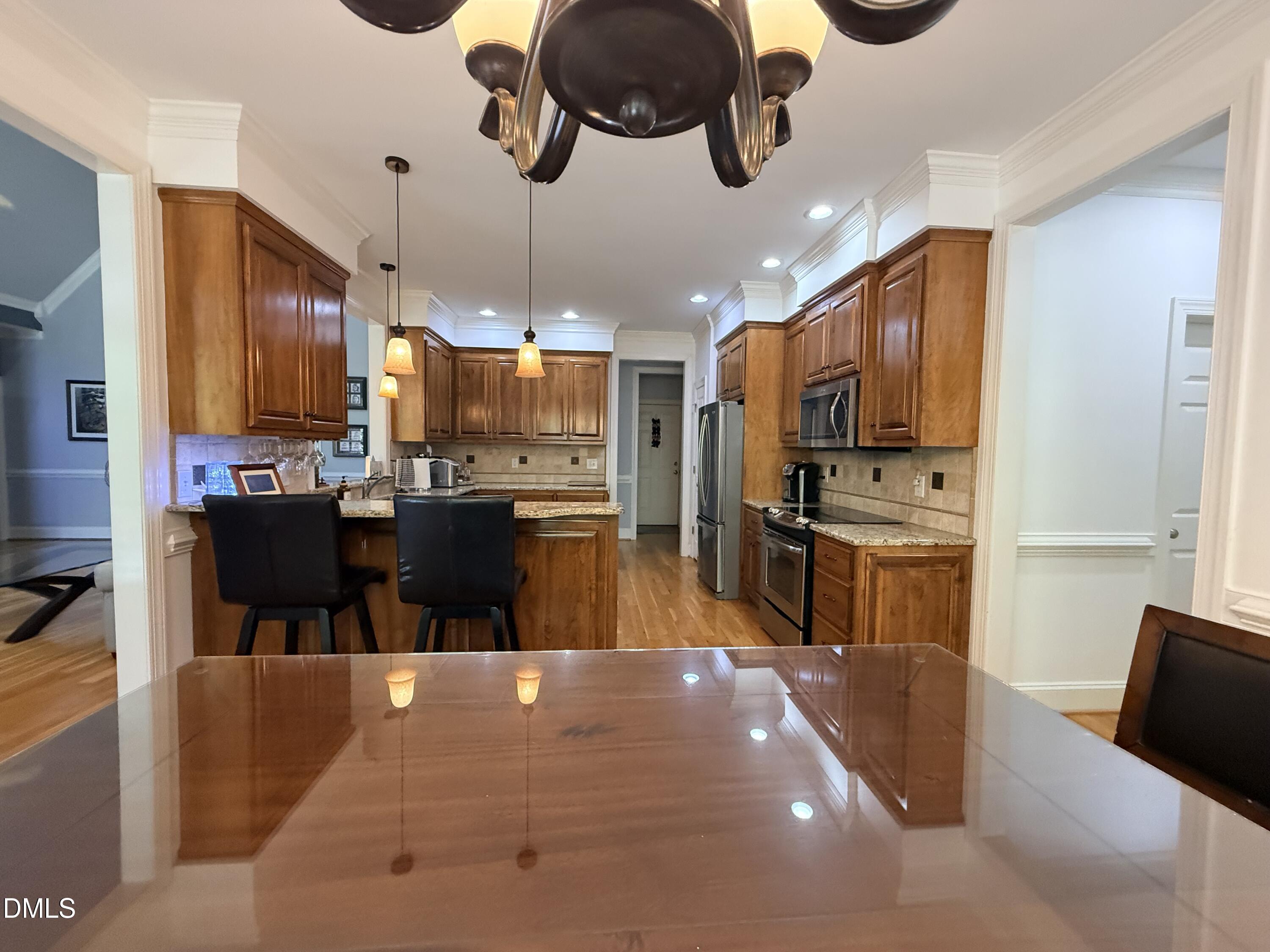 217 Clearwater Drive Roxboro, NC 27574 - Photo 18 of 57 a large kitchen with a table chairs refrigerator and microwave