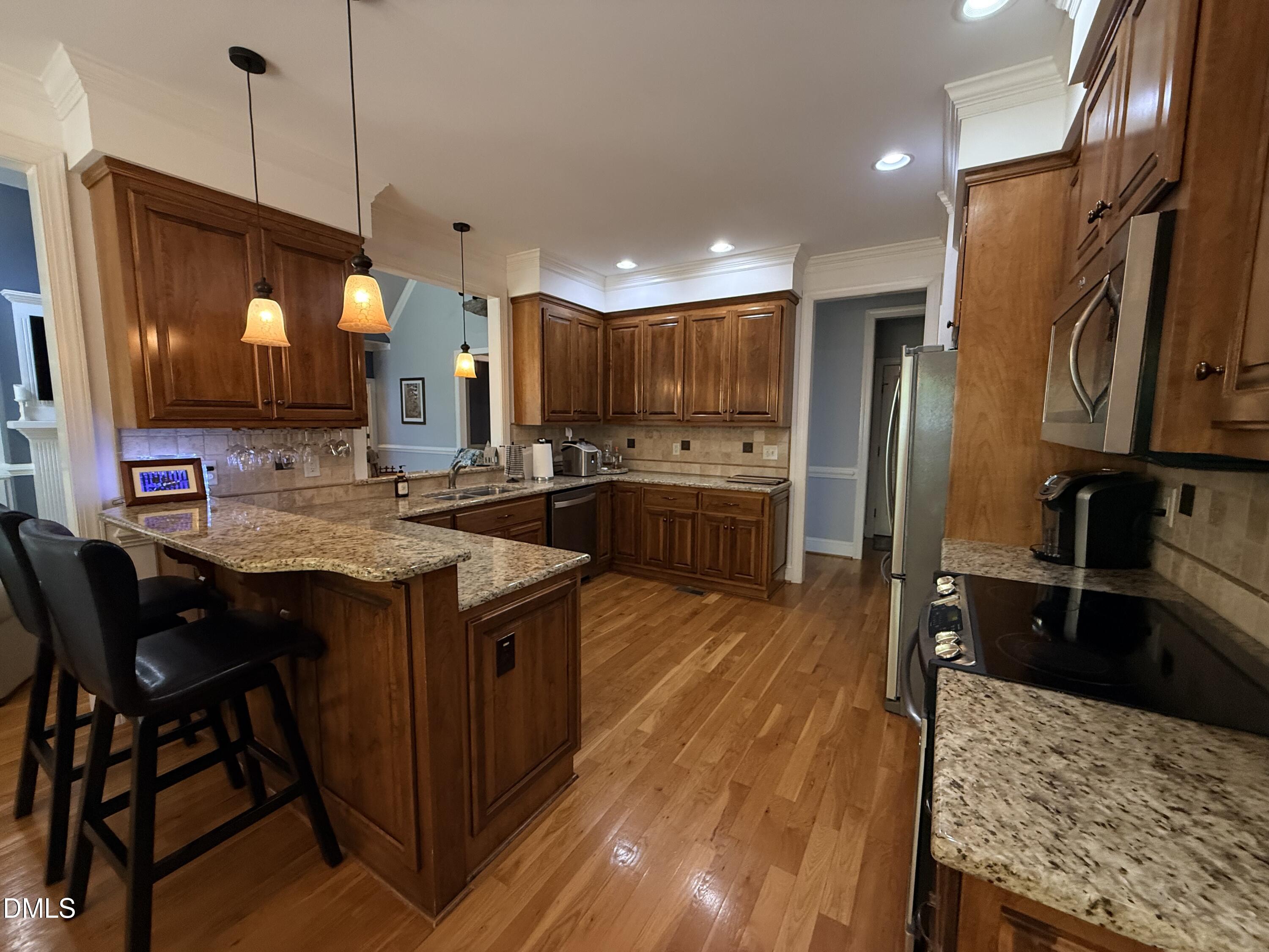 217 Clearwater Drive Roxboro, NC 27574 - Photo 22 of 57 a kitchen with stainless steel appliances granite countertop a sink a stove and a refrigerator