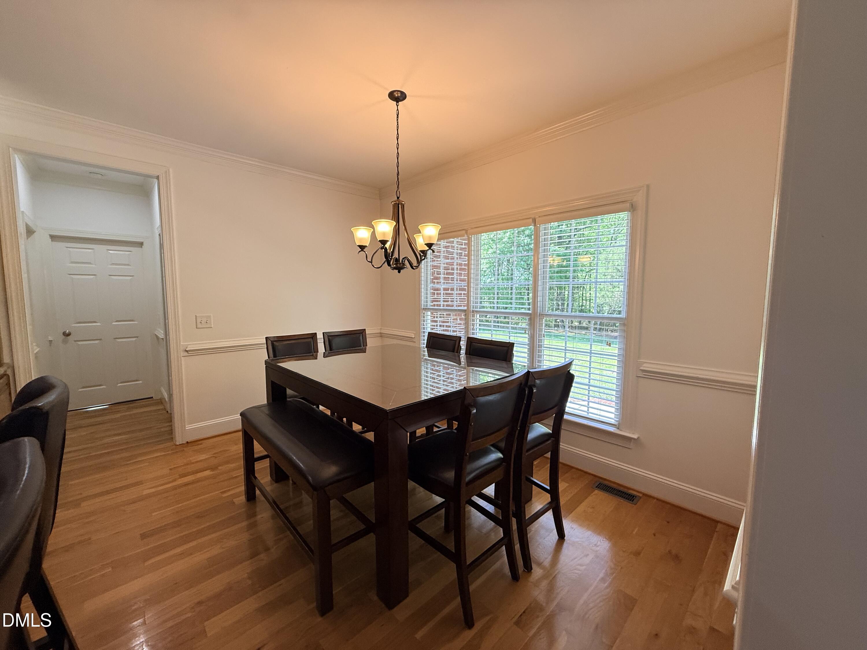 217 Clearwater Drive Roxboro, NC 27574 - Photo 24 of 57 a view of a dining room with furniture window and wooden floor