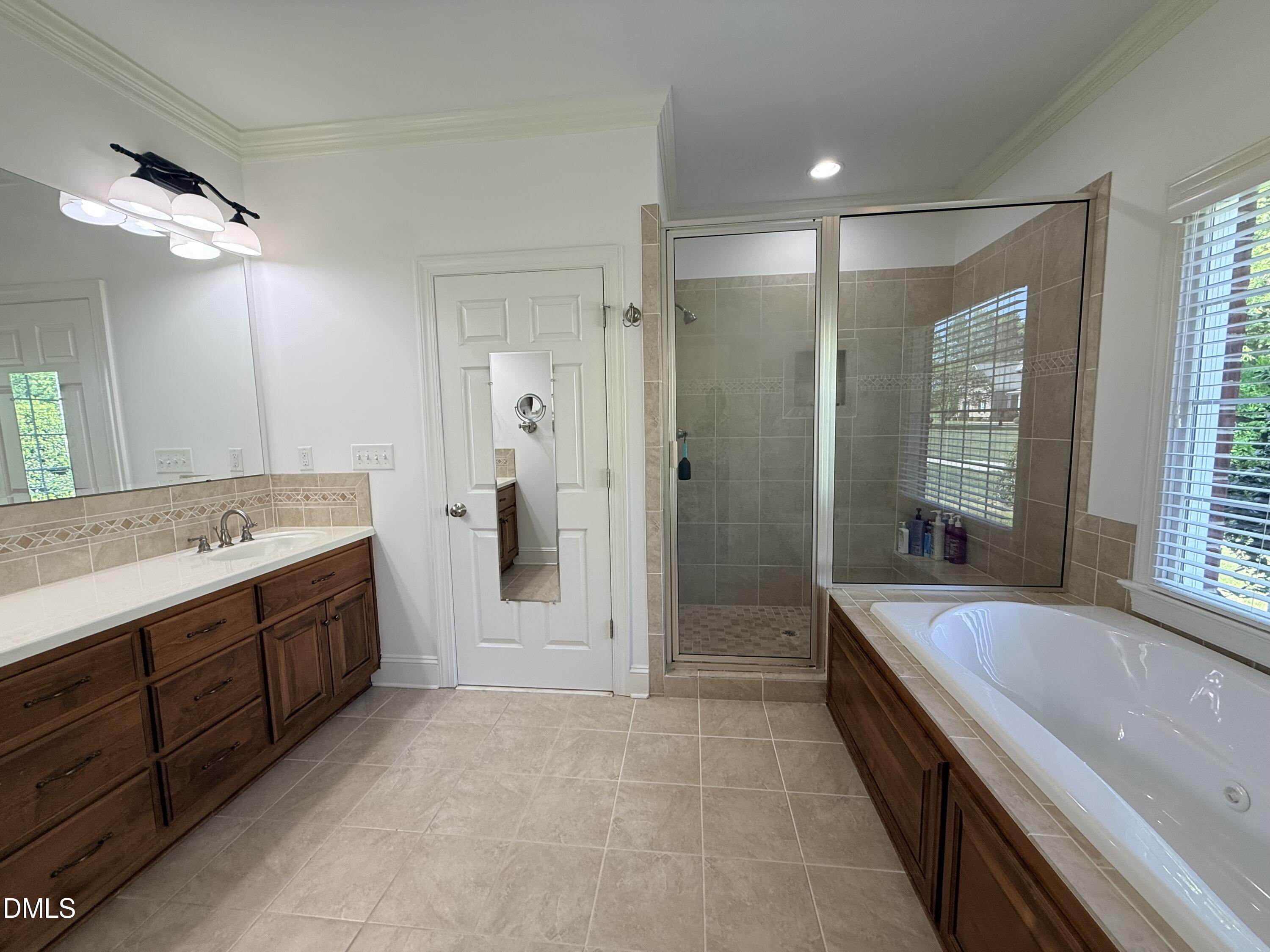 217 Clearwater Drive Roxboro, NC 27574 - Photo 32 of 57 a spacious bathroom with a bathtub shower sink and mirror