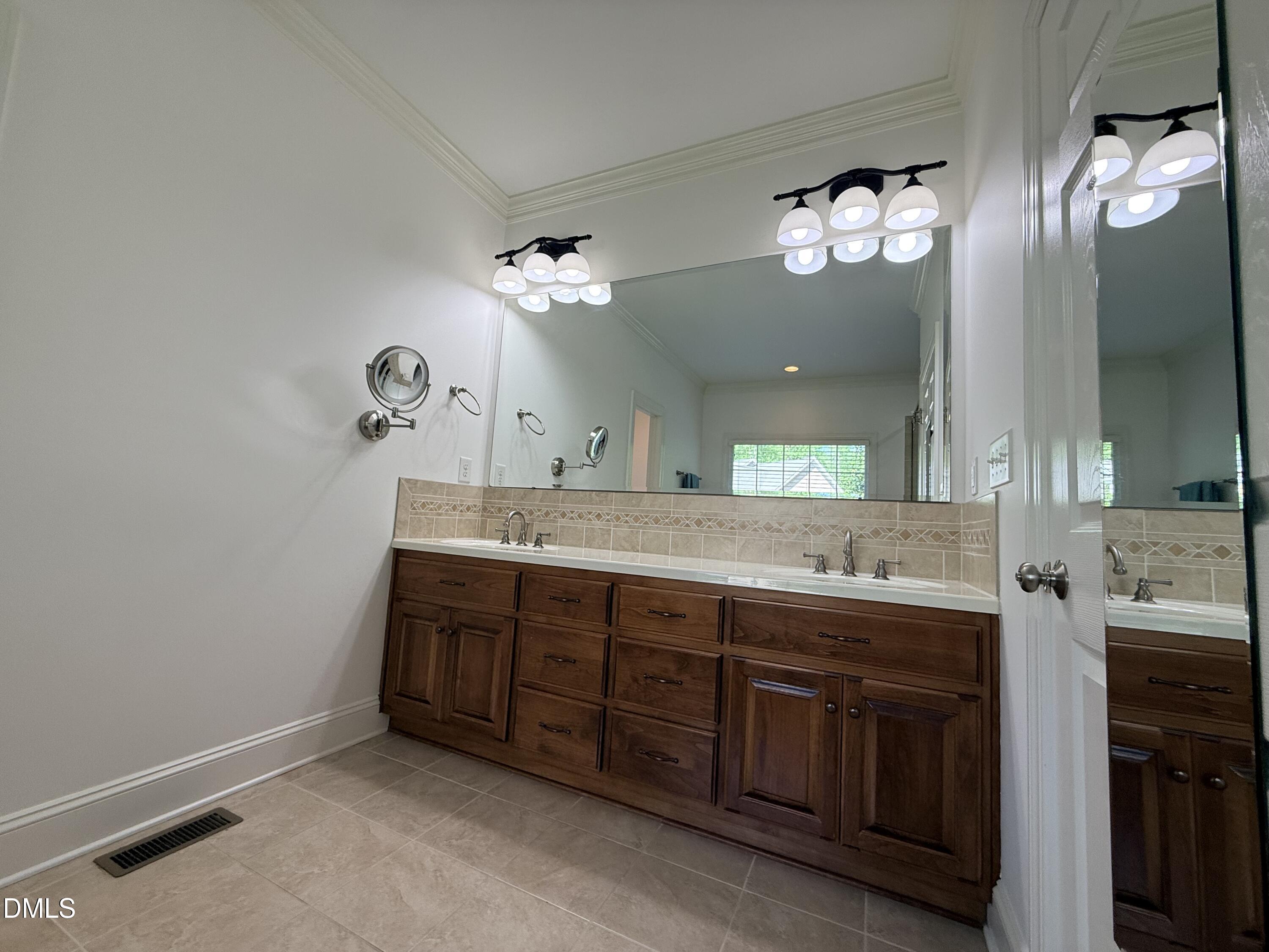 217 Clearwater Drive Roxboro, NC 27574 - Photo 35 of 57 a bathroom with a double vanity sink and a mirror