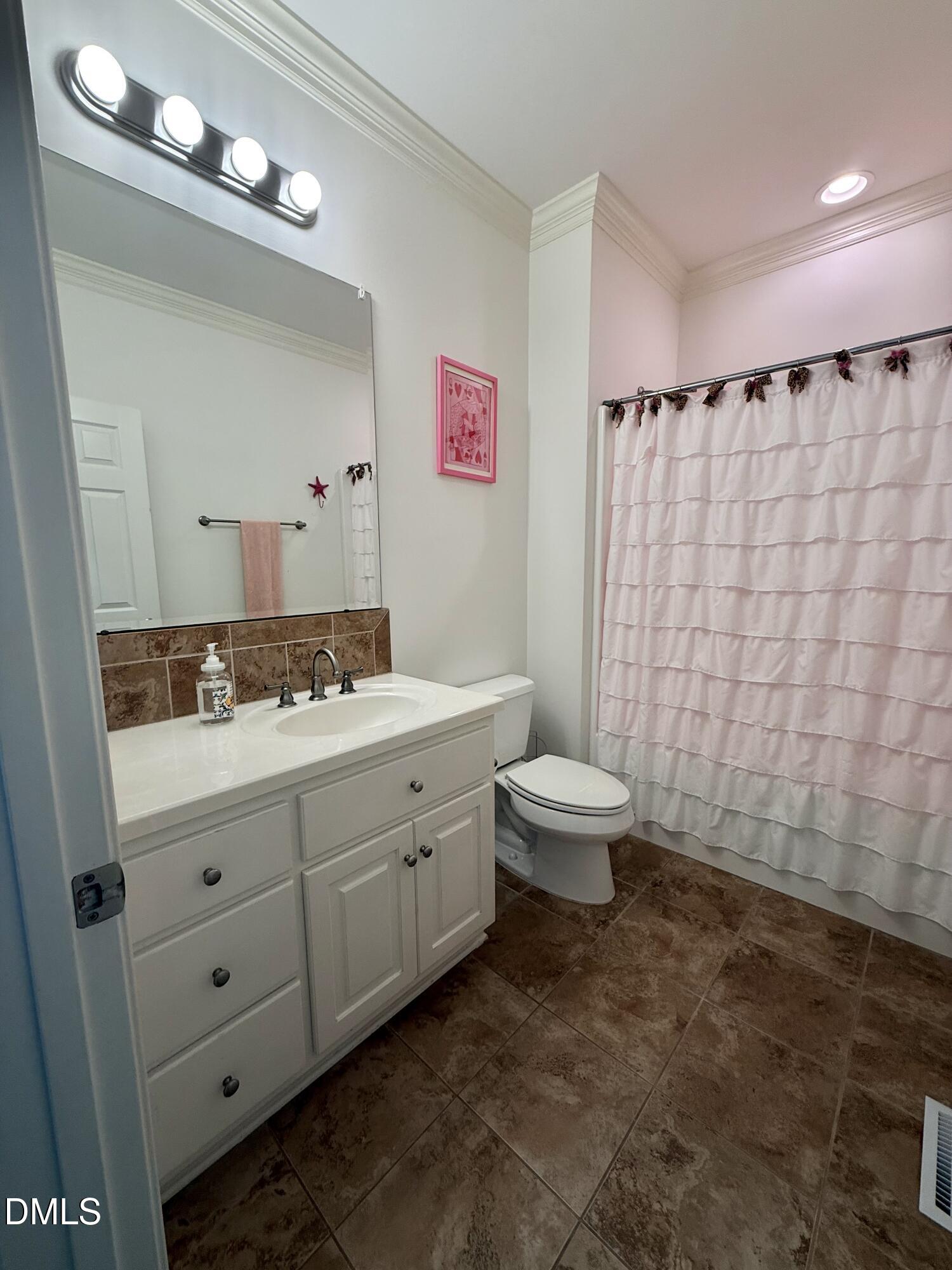217 Clearwater Drive Roxboro, NC 27574 - Photo 40 of 57 a bathroom with a double vanity sink toilet and a mirror