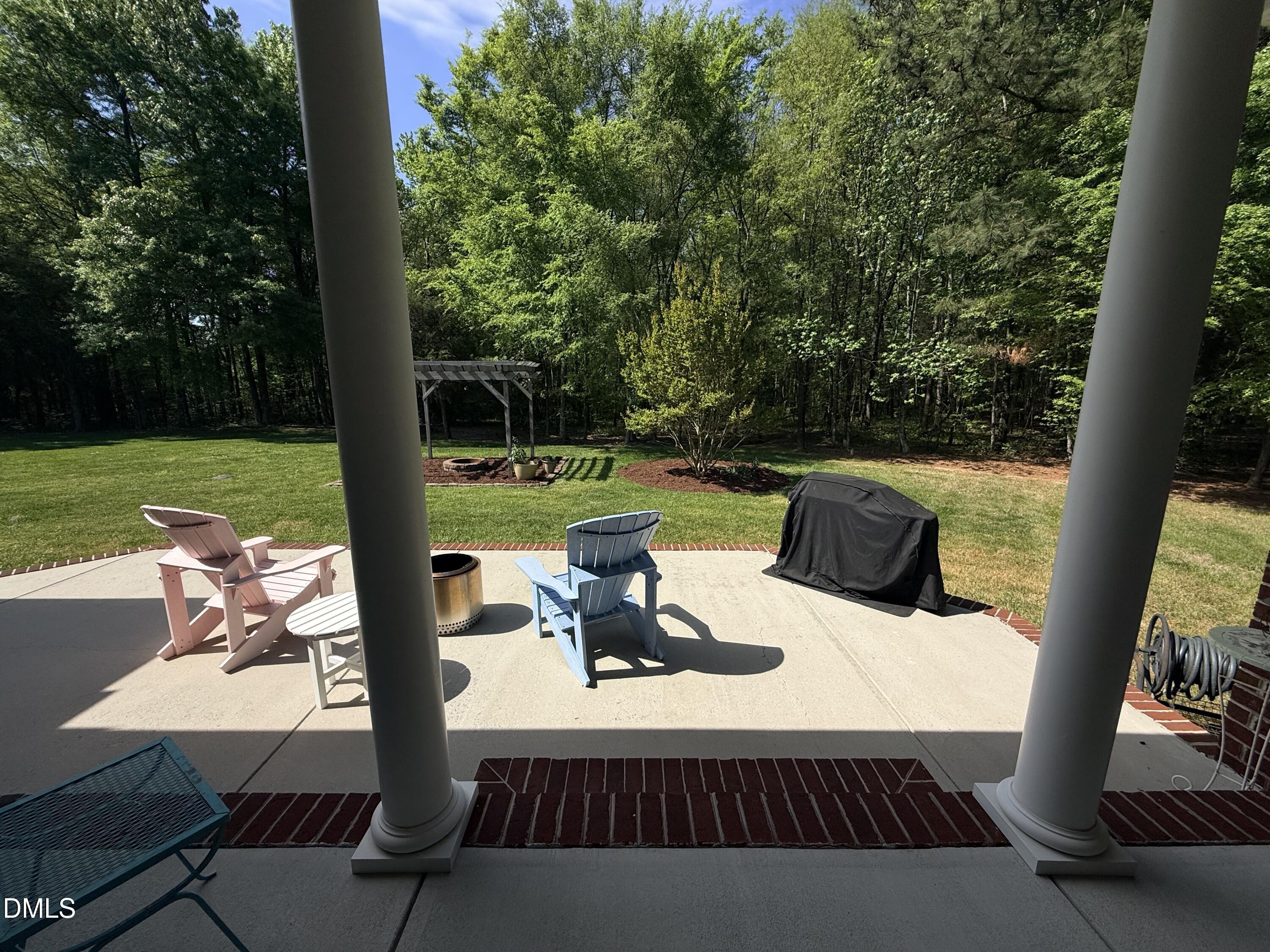 217 Clearwater Drive Roxboro, NC 27574 - Photo 46 of 57 a view of a patio with a table chairs and a fire pit