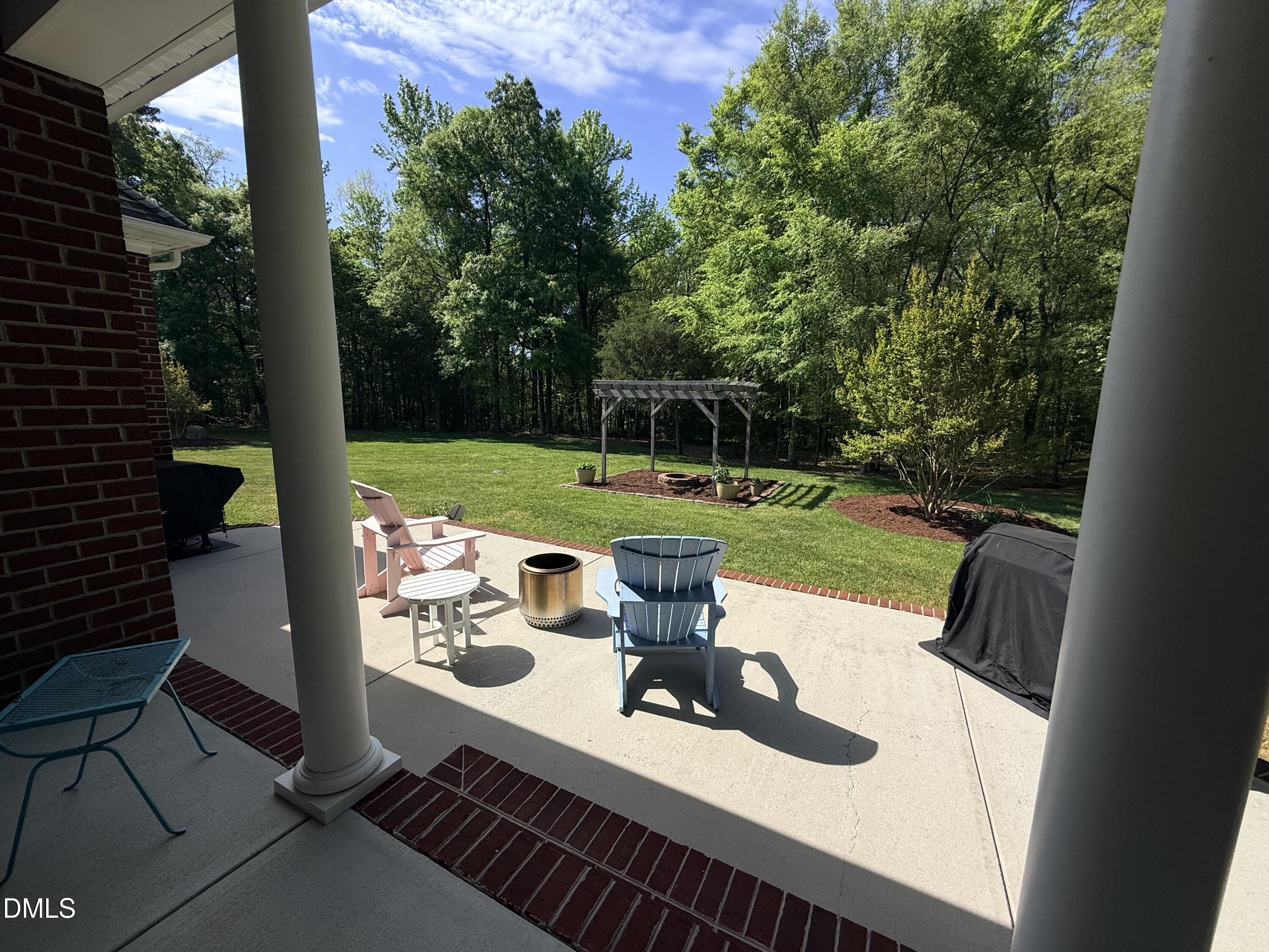 217 Clearwater Drive Roxboro, NC 27574 - Photo 47 of 57 a view of a wooden chairs and table in patio