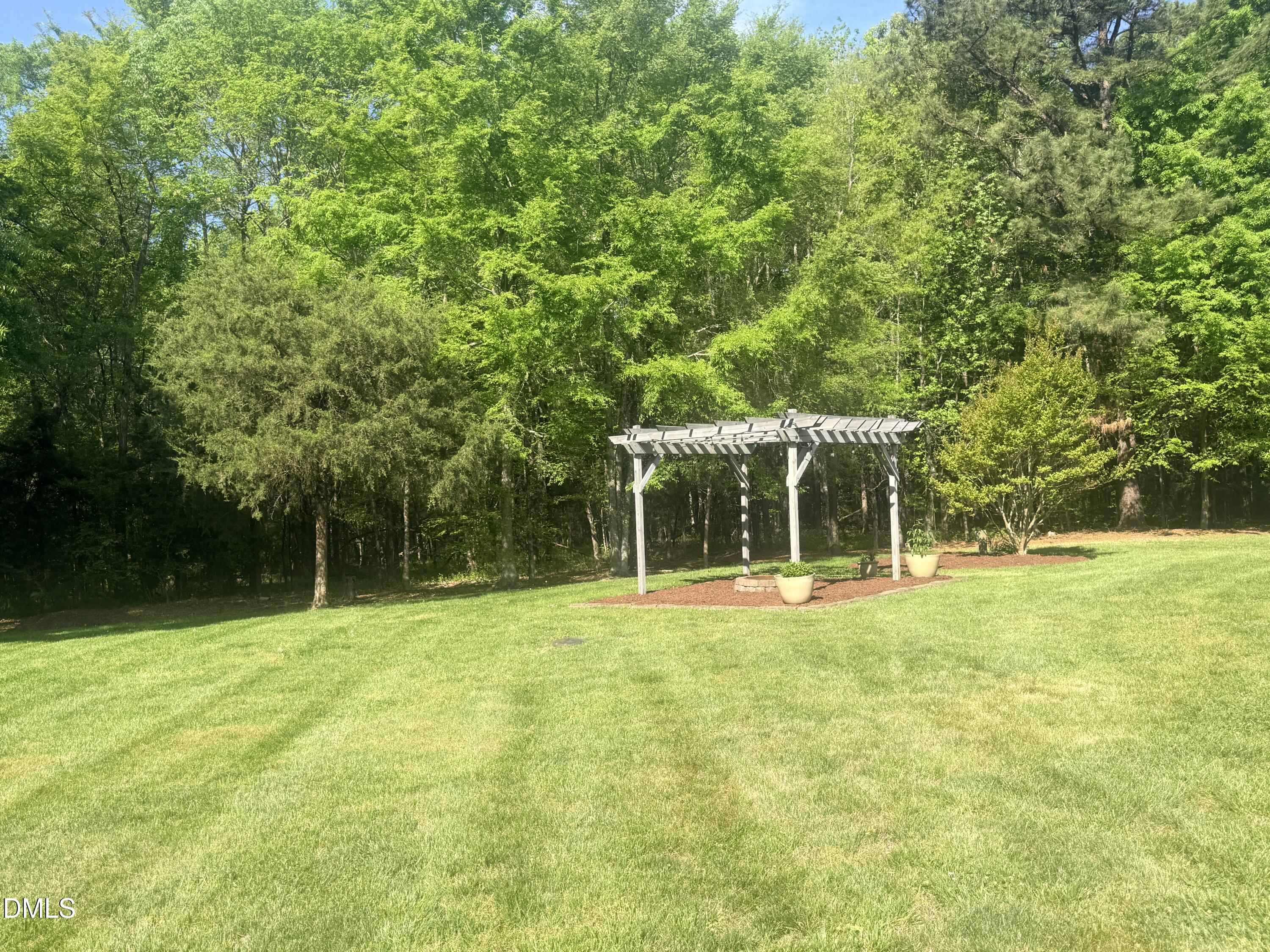 217 Clearwater Drive Roxboro, NC 27574 - Photo 48 of 57 a view of a tennis ground with large trees
