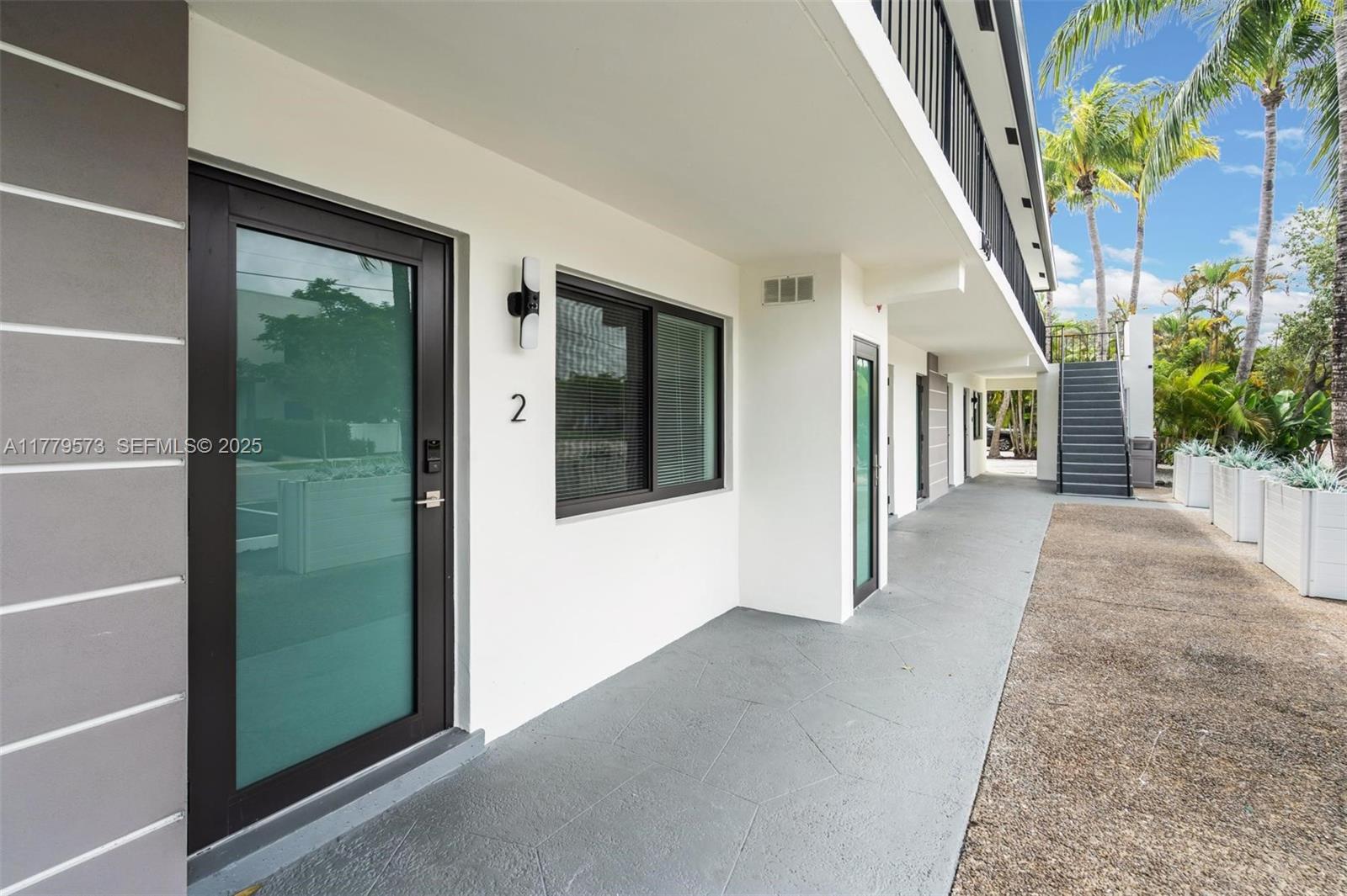 1630 Southwest 4th Avenue, Unit 2 Fort Lauderdale, FL 33315 - Photo 2 of 8 a view of a hallway with wooden floor and stairs