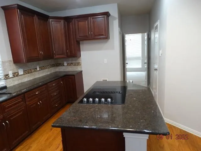 a kitchen with sink a refrigerator and cabinets