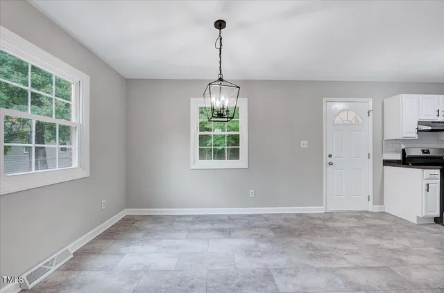 a view of a room with window and entryway