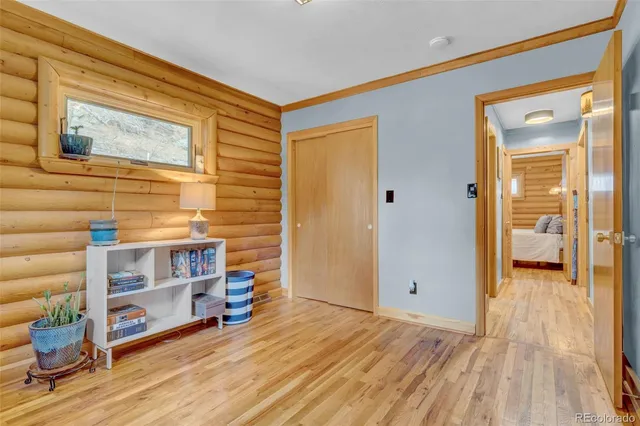 a view of room with wooden floor and windows