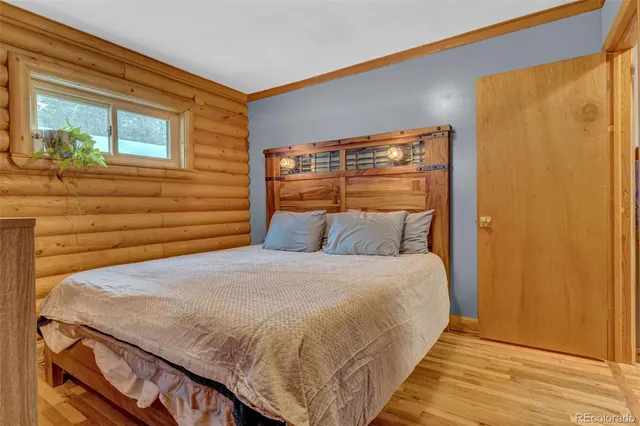 a bed sitting in a bedroom next to a window