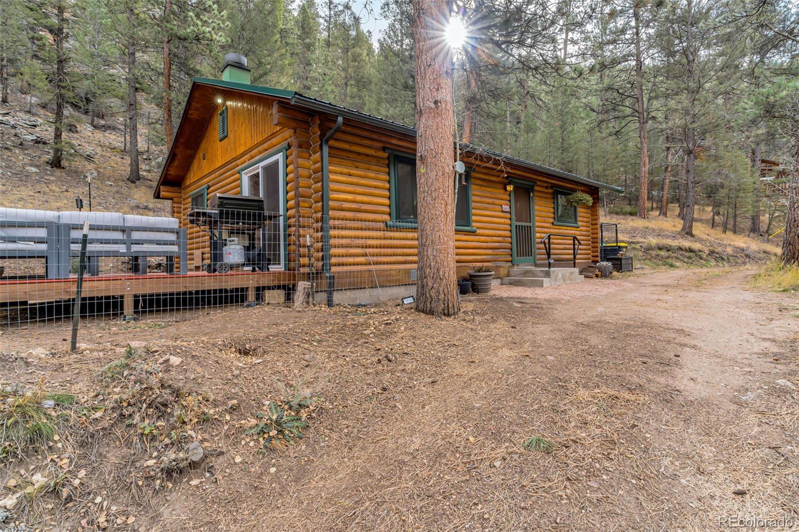 14601 South Elk Creek Road Pine, CO 80470 - Photo 18 of 26 a view of a house with a yard and wooden fence