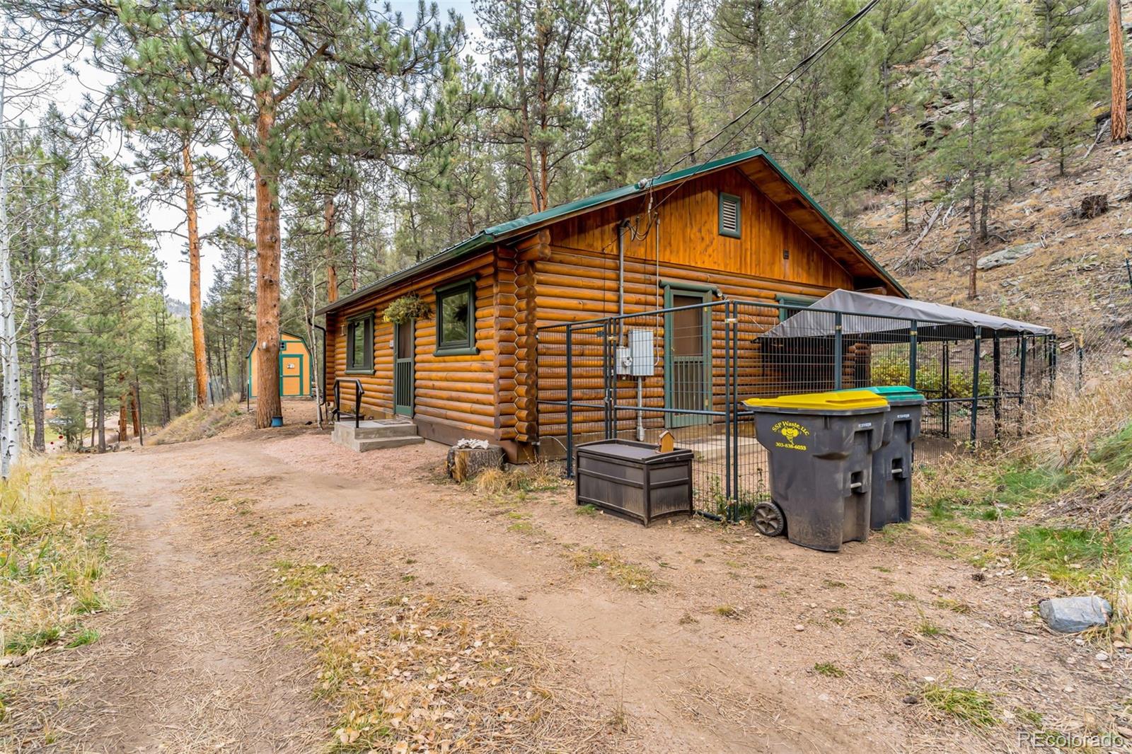 14601 South Elk Creek Road Pine, CO 80470 - Photo 19 of 26 a view of house with backyard and seating area