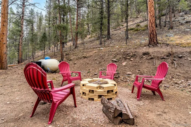 a backyard of a house with table and chairs