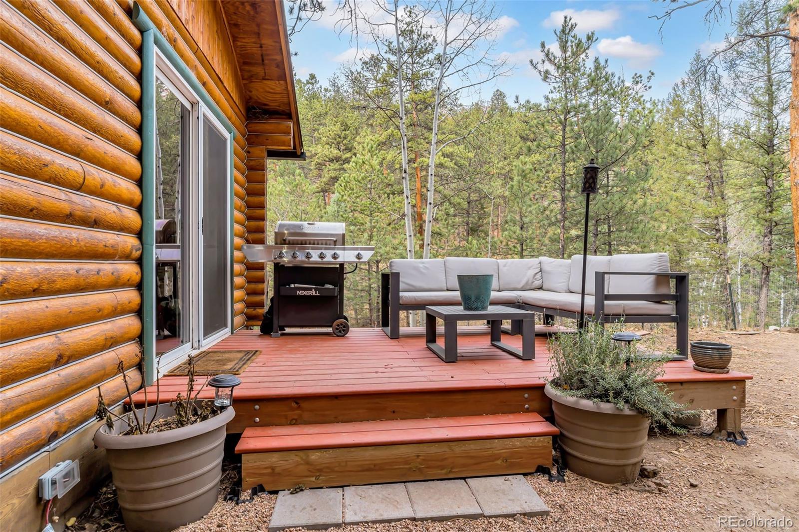 14601 South Elk Creek Road Pine, CO 80470 - Photo 22 of 26 a wooden bench sitting in front of a building