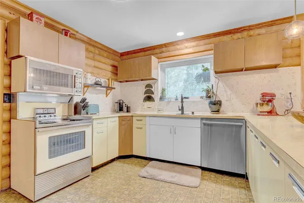 a kitchen with cabinets appliances and a sink