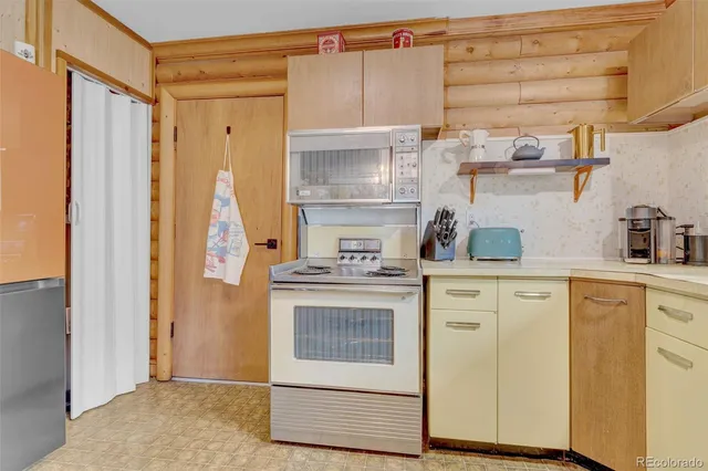 a kitchen with a stove cabinets and wooden floor