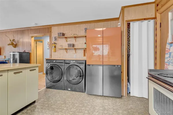 a view of a storage and utility room with washer and dryer