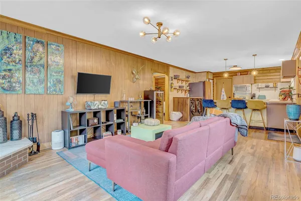 a living room with furniture a flat screen tv and a floor to ceiling window