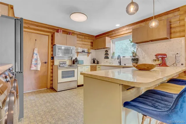 a kitchen with stainless steel appliances a sink and a refrigerator