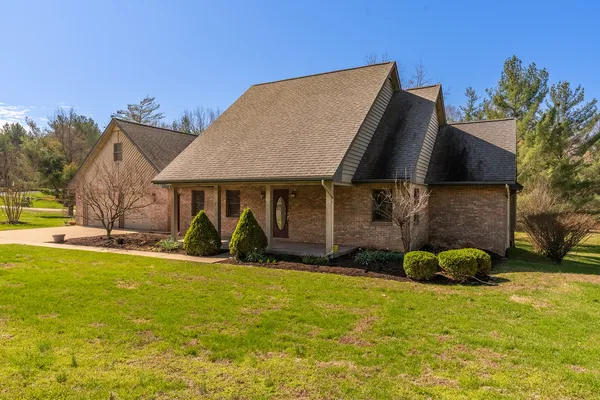 an aerial view of a house with garden space and street view