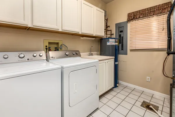 an empty room with ceiling fan and windows