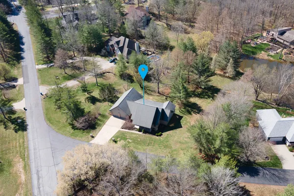 an aerial view of a house with yard