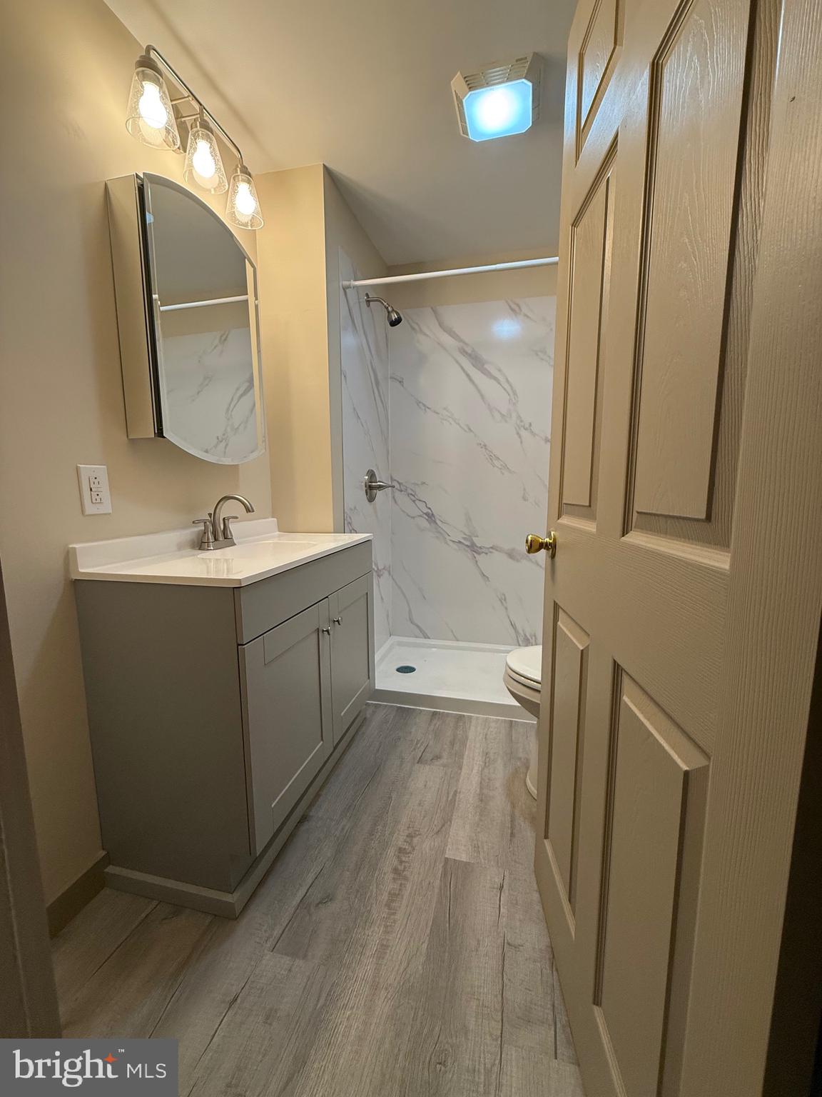 9505 Main Street Huntingdon, PA 16652 - Photo 20 of 72 a bathroom with a sink a mirror a vanity and a shower