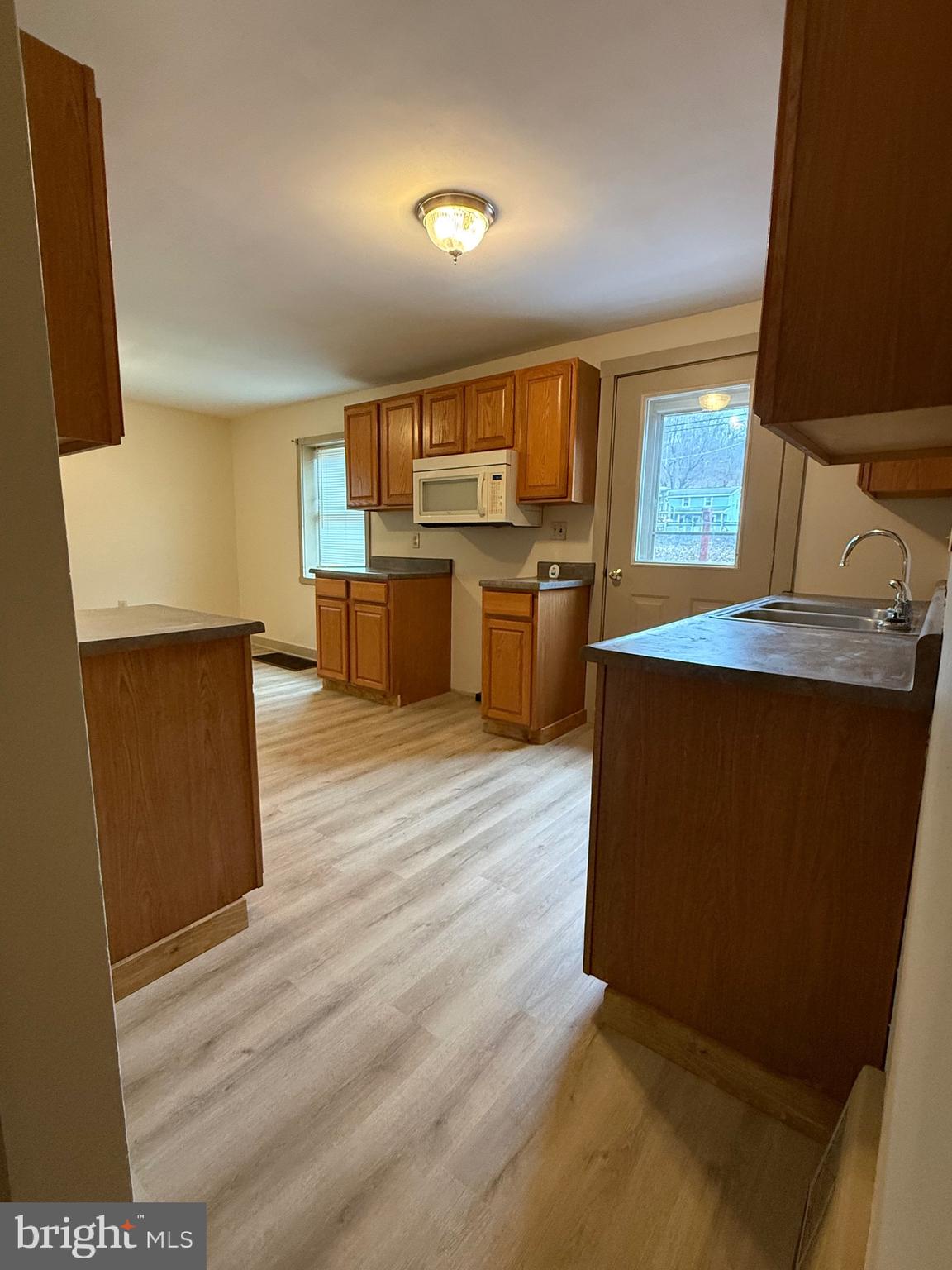 9505 Main Street Huntingdon, PA 16652 - Photo 35 of 72 a kitchen with stainless steel appliances wooden floors and view living room