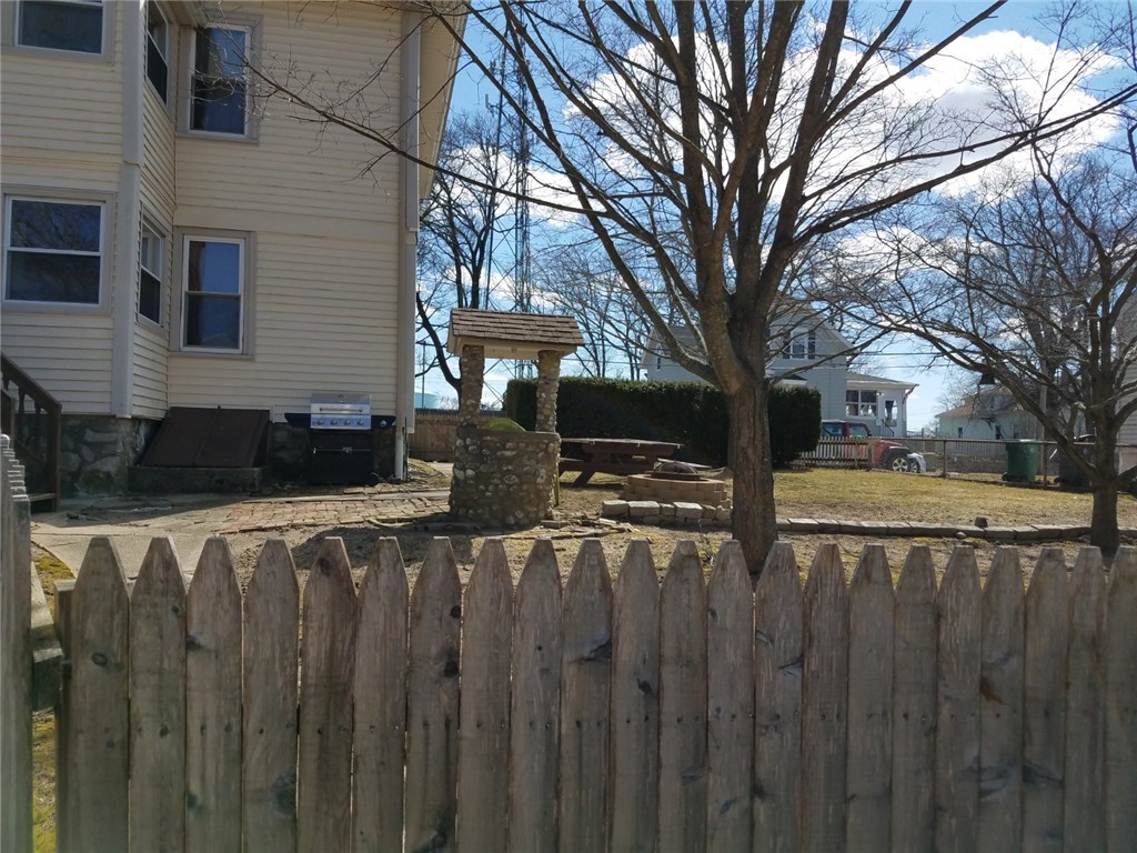 421 Welles Street Woonsocket, RI 02895 - Photo 23 of 26 Partial backyard, walkways, stairs and bulkhead from Driveway..