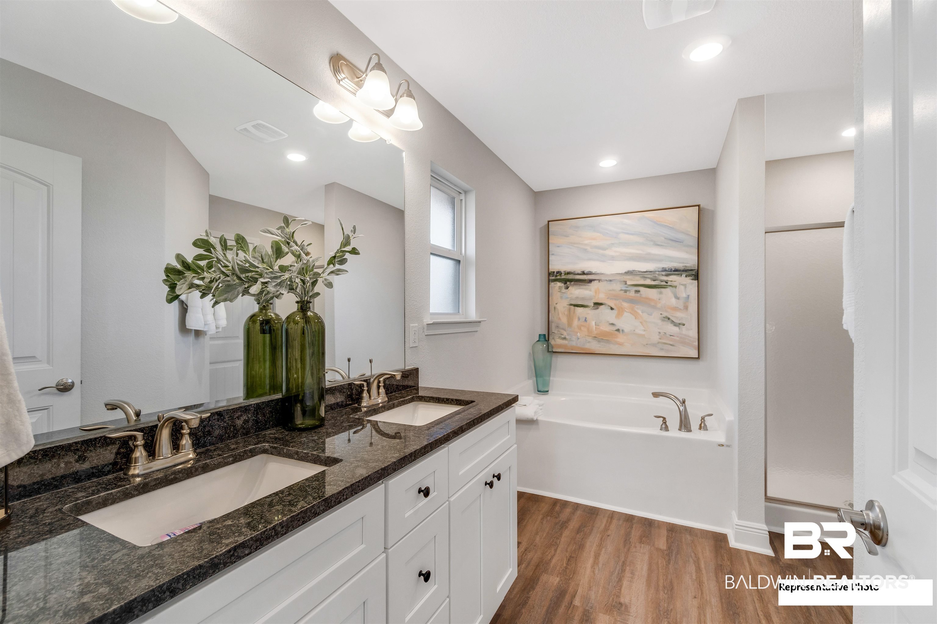 660 Mayflower Drive Foley, AL 36535 - Photo 23 of 36 Bathroom featuring wood-type flooring, vanity, and a tub to relax in