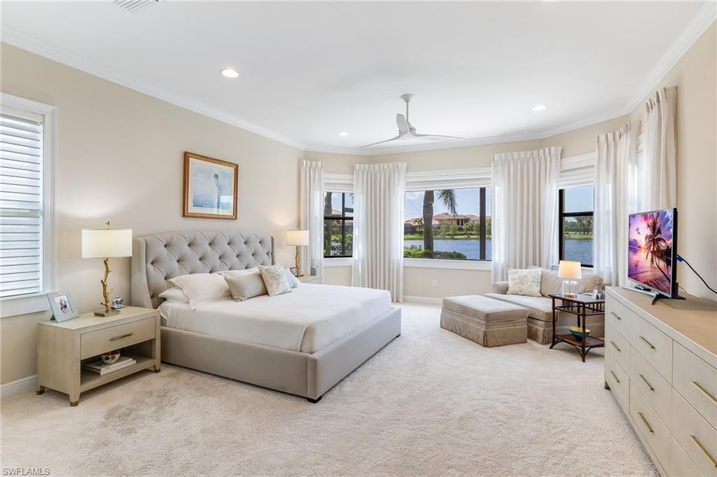 12749 Dundee Lane Naples, FL 34120 - Photo 15 of 45 a spacious bedroom with a bed and a large window