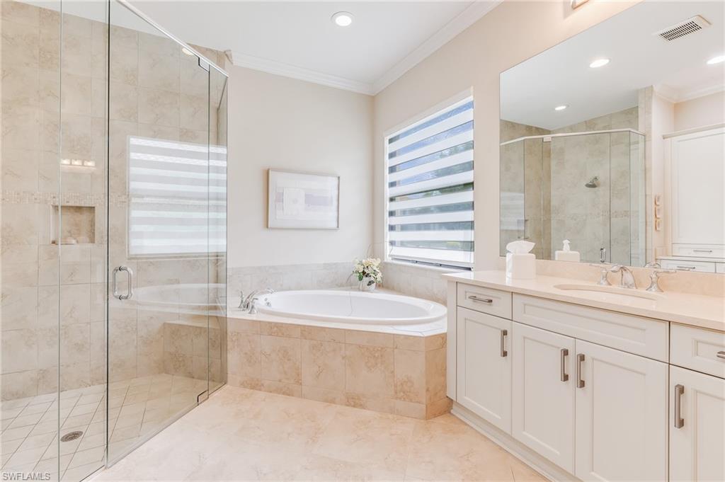 12749 Dundee Lane Naples, FL 34120 - Photo 18 of 45 a bathroom with a bathtub sink vanity granite and a shower