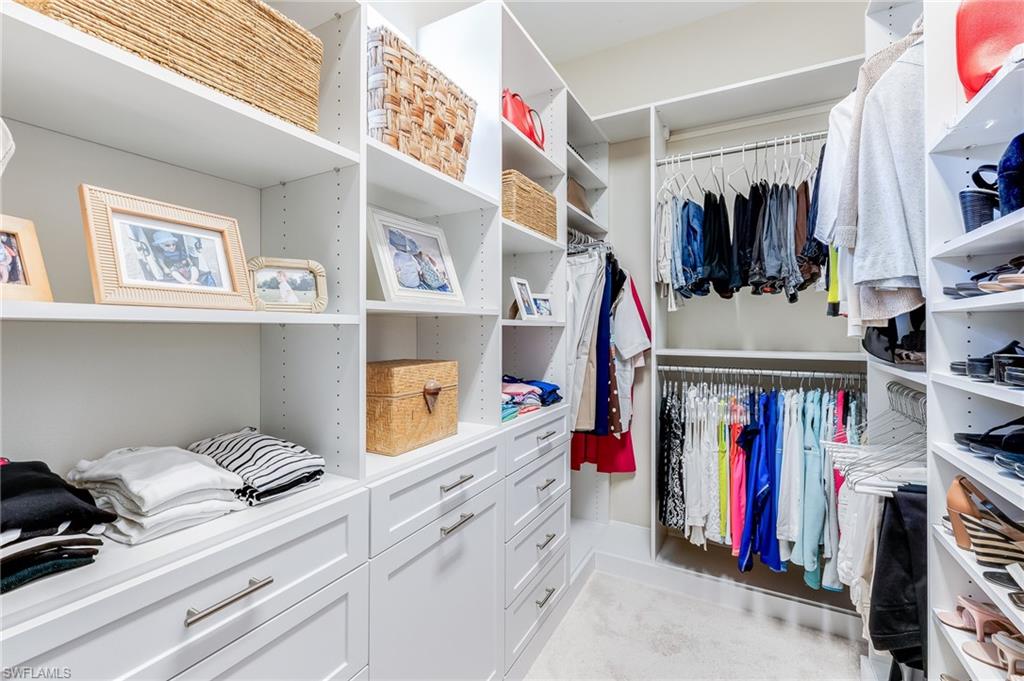 12749 Dundee Lane Naples, FL 34120 - Photo 20 of 45 a view of walk in closet with clothes