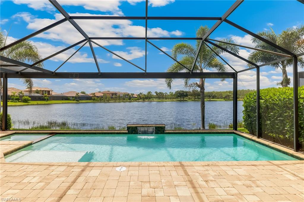 12749 Dundee Lane Naples, FL 34120 - Photo 2 of 45 a view of a swimming pool with a patio