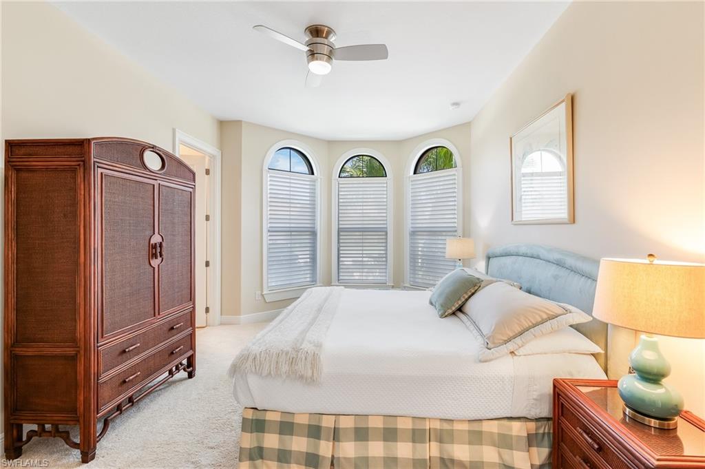12749 Dundee Lane Naples, FL 34120 - Photo 21 of 45 a bedroom with a bed and a window