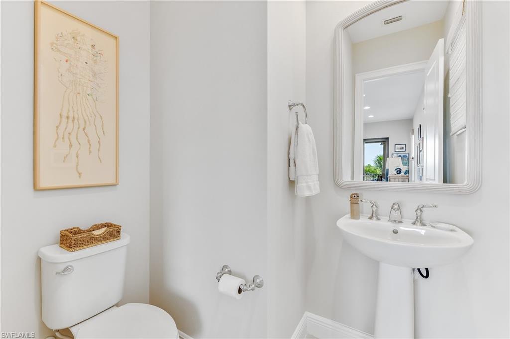 12749 Dundee Lane Naples, FL 34120 - Photo 28 of 45 a bathroom with a toilet sink and mirror