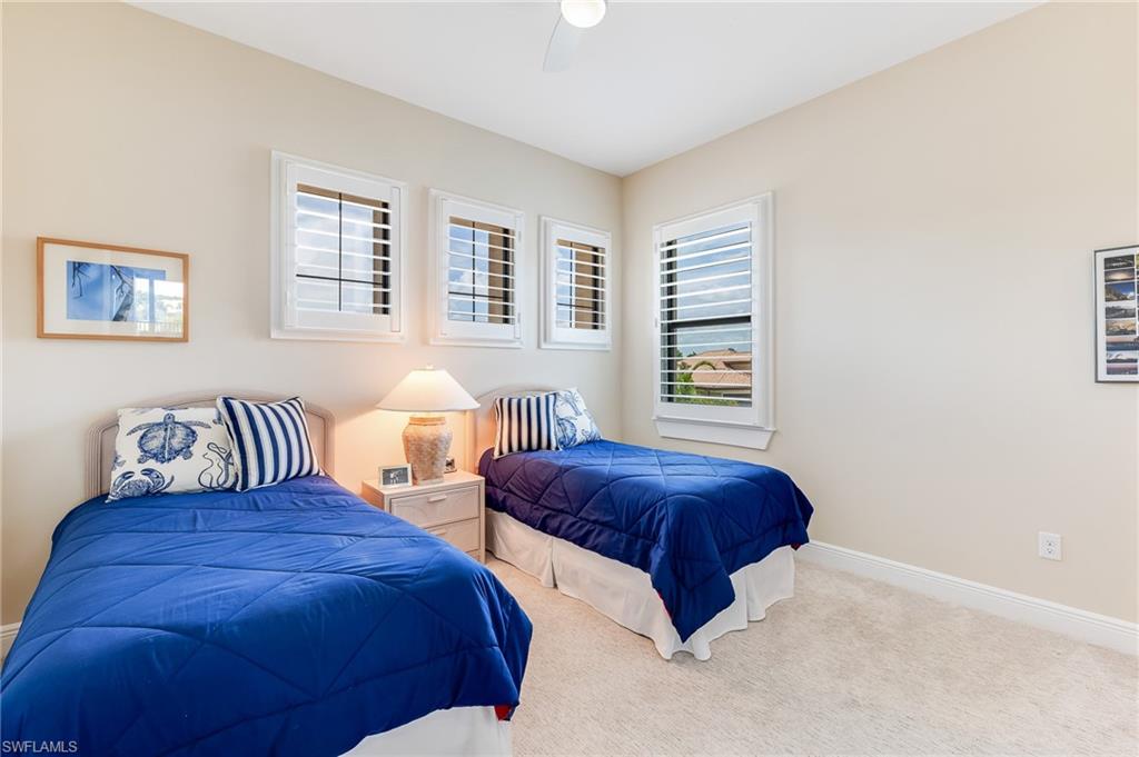12749 Dundee Lane Naples, FL 34120 - Photo 29 of 45 a bedroom with bed and a window