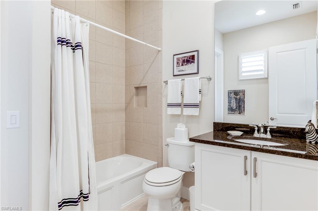 12749 Dundee Lane Naples, FL 34120 - Photo 30 of 45 a bathroom with a granite countertop sink toilet and shower