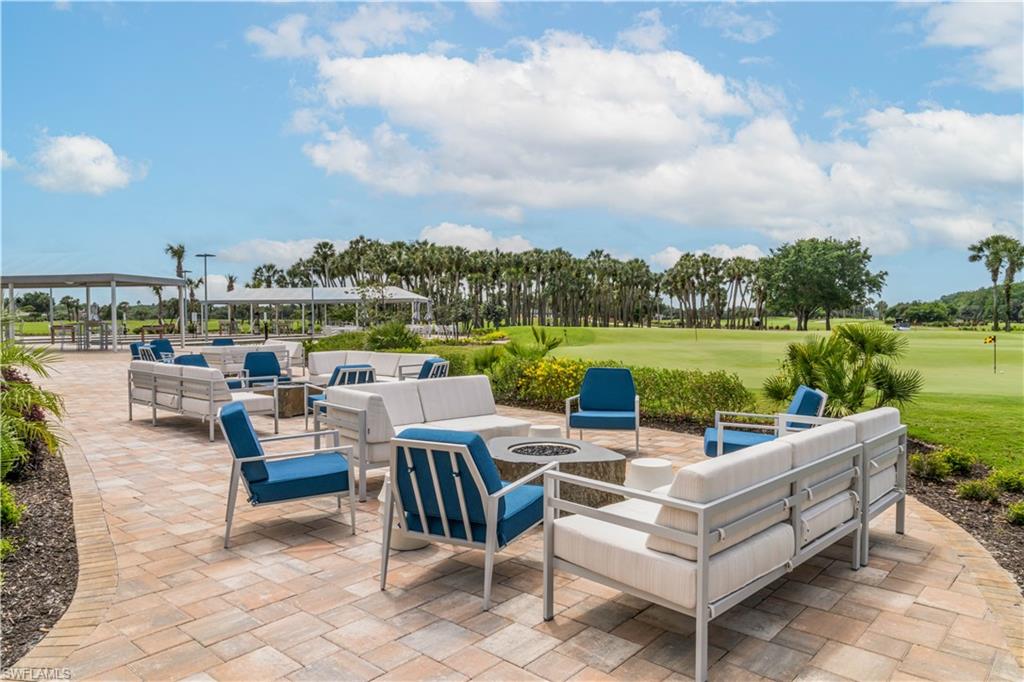 12749 Dundee Lane Naples, FL 34120 - Photo 42 of 45 a view of a patio with couches potted plants and a lake view