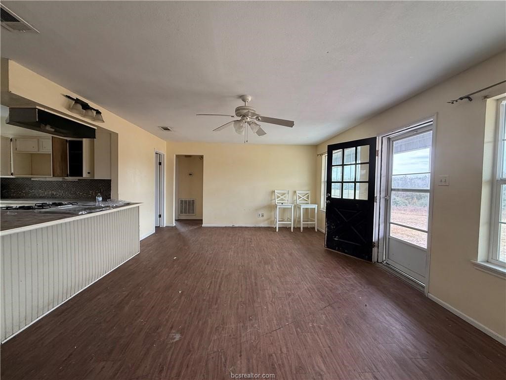 9776 Calhoun Road Bryan, TX 77808 - Photo 11 of 50 a view of an empty room with a window and wooden floor