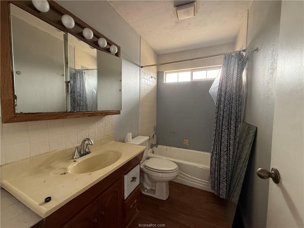 9776 Calhoun Road Bryan, TX 77808 - Photo 13 of 50 a bathroom with a sink a toilet and shower