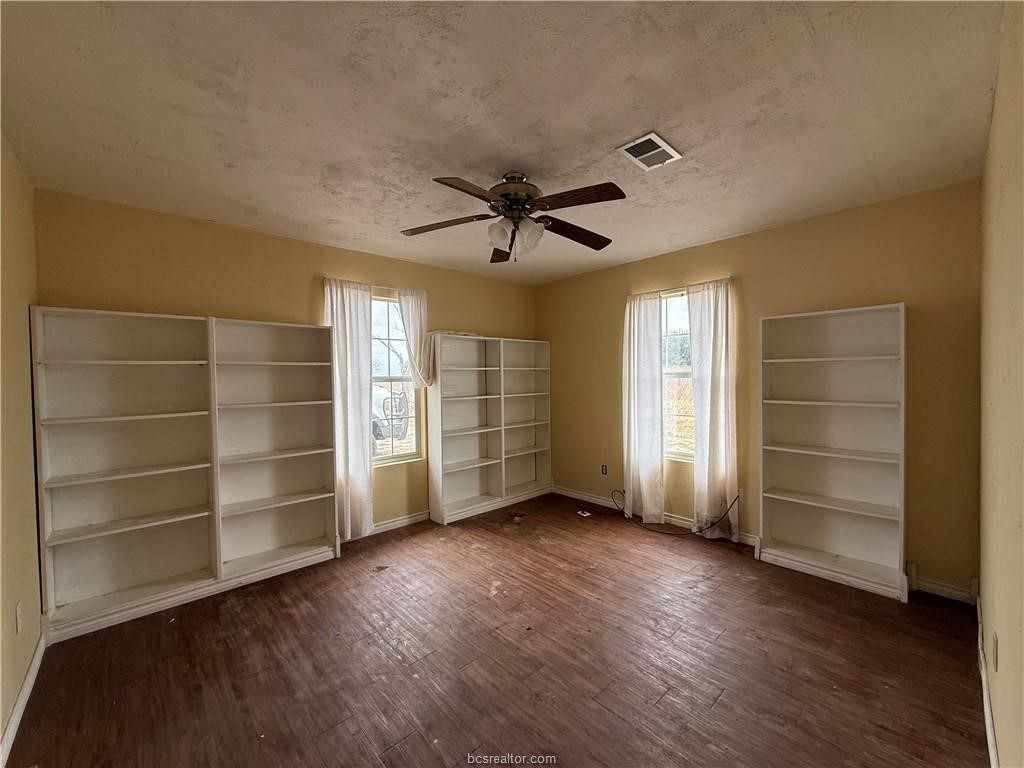 9776 Calhoun Road Bryan, TX 77808 - Photo 14 of 50 a view of an empty room with a window and a kitchen