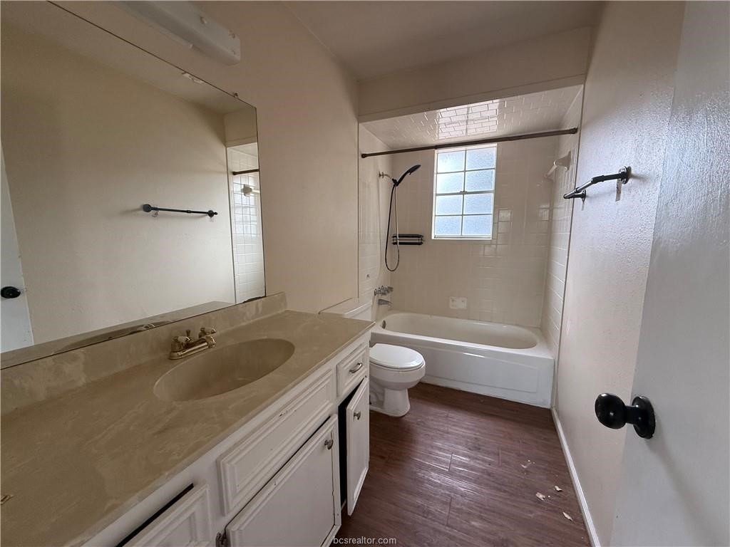 9776 Calhoun Road Bryan, TX 77808 - Photo 15 of 50 a bathroom with a granite countertop sink toilet and shower