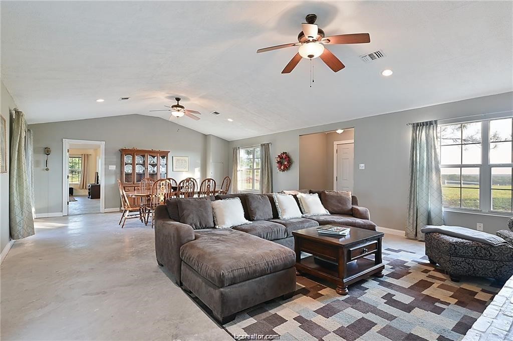 9776 Calhoun Road Bryan, TX 77808 - Photo 19 of 50 a living room with furniture and a large window