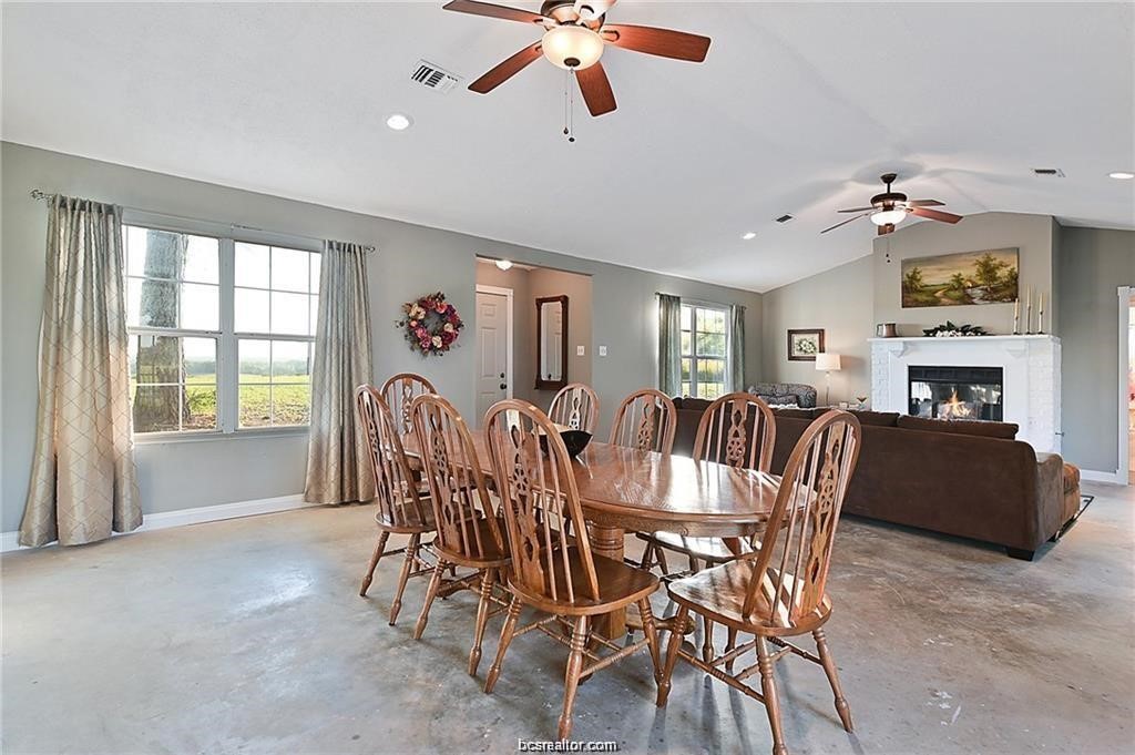 9776 Calhoun Road Bryan, TX 77808 - Photo 21 of 50 a view of a dining room with furniture window and wooden floor