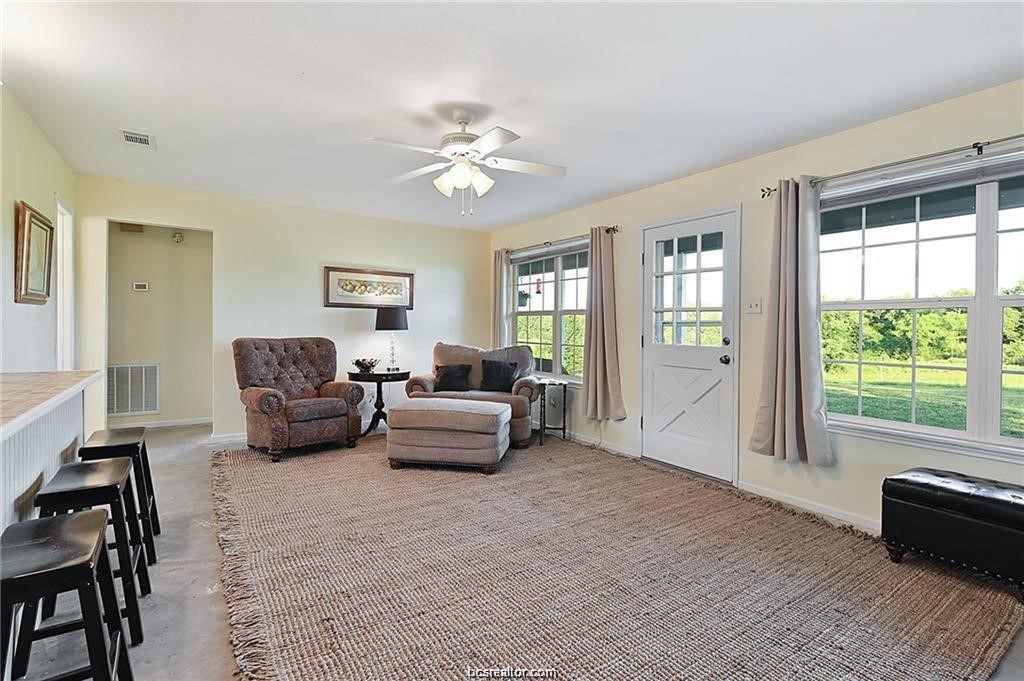 9776 Calhoun Road Bryan, TX 77808 - Photo 25 of 50 a living room with furniture and a large window