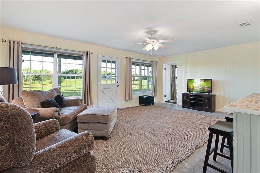 9776 Calhoun Road Bryan, TX 77808 - Photo 26 of 50 a living room with furniture and a flat screen tv