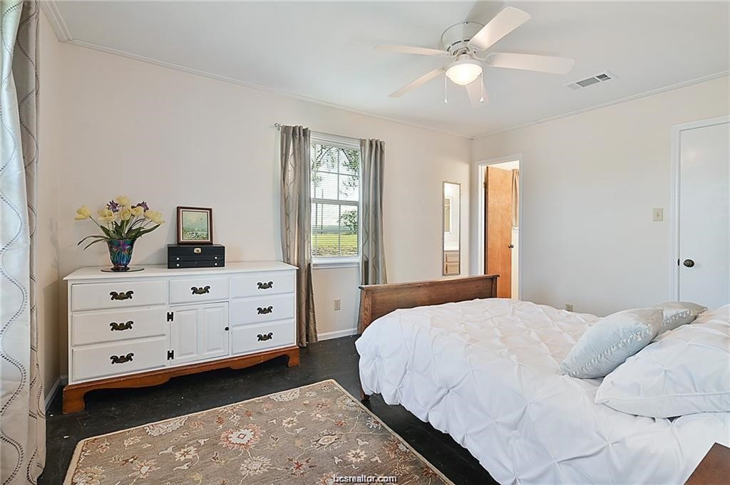 9776 Calhoun Road Bryan, TX 77808 - Photo 29 of 50 a bedroom with a bed dresser and a window